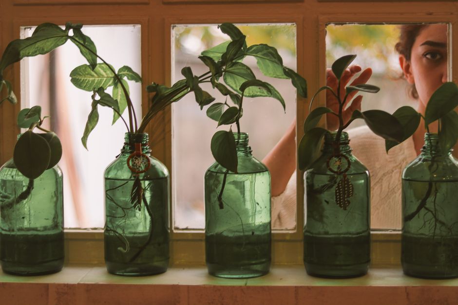Creatieve bloemenarrangementen in gerecyclede vazen.